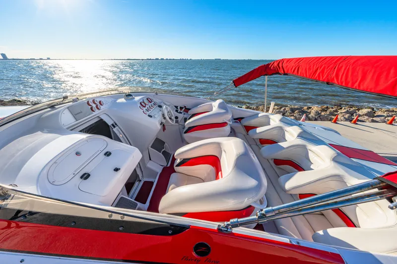 Slide: The Image of 2003 Donzi 33 ZX Daytona boat interior with red and white seating, ocean view. - 6