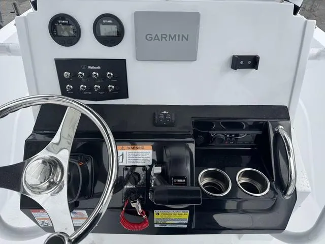 Slide: The Image of 2025 Wellcraft 202 Fisherman dashboard with Garmin system and Yamaha controls. - 10