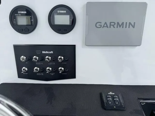 Slide: The Image of Control panel of 2025 Wellcraft 202 Fisherman with Garmin and Yamaha displays. - 12