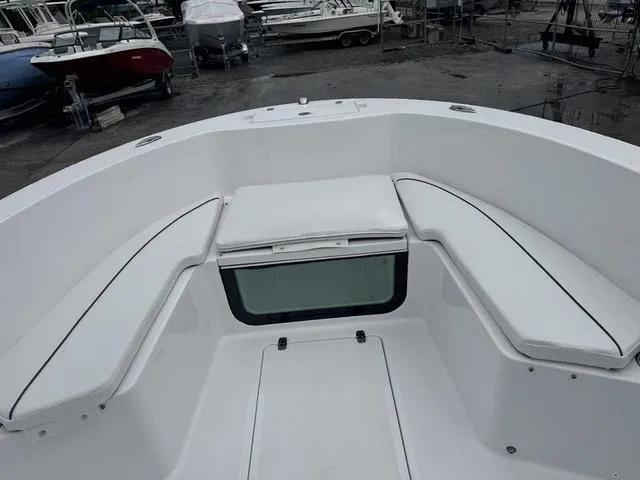 Slide: The Image of 2025 Wellcraft 202 Fisherman boat interior with white cushioned seating. - 14