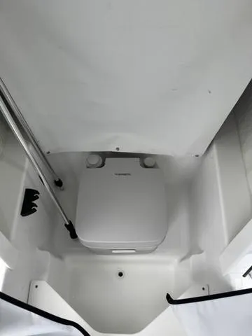 Slide: The Image of 2025 Wellcraft 202 Fisherman boat interior with compact marine toilet. - 17