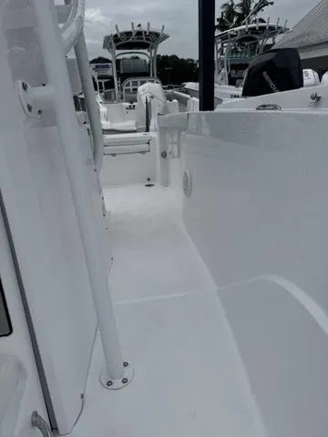 Slide: The Image of 2025 Wellcraft 202 Fisherman boat interior, showcasing sleek white deck and seating area. - 18