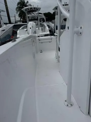 Slide: The Image of 2025 Wellcraft 202 Fisherman boat interior, showcasing sleek white deck design. - 19