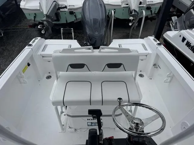 Slide: The Image of 2025 Wellcraft 202 Fisherman boat interior with seating and steering wheel. - 20