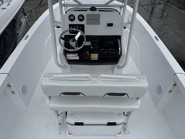 Slide: The Image of 2025 Wellcraft 202 Fisherman boat cockpit with steering wheel, controls, and seating. - 3