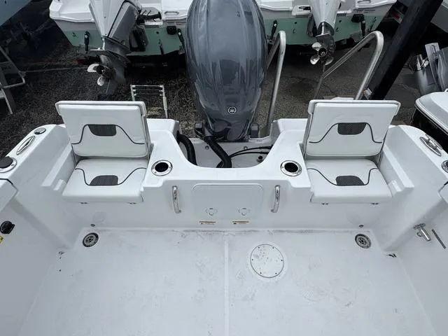 Slide: The Image of 2025 Wellcraft 202 Fisherman boat interior with seating and motor, showcasing modern design. - 7