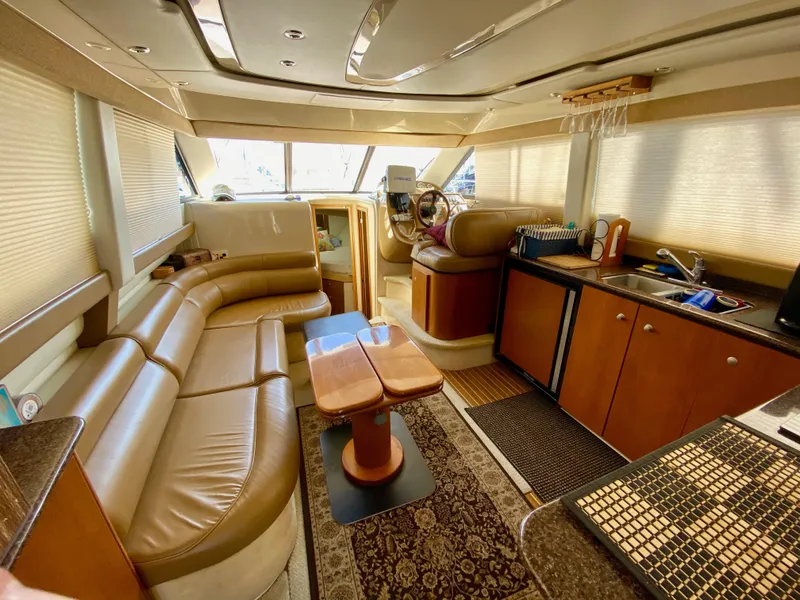 Slide: The Image of Luxurious interior of 2002 Bayliner 3488 Command Bridge yacht with leather seating and kitchenette. - 13