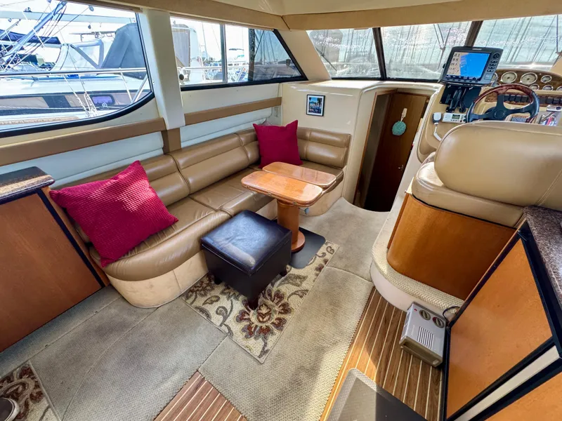 Slide: The Image of Interior of 2002 Bayliner 3488 Command Bridge with seating, table, and helm. - 14