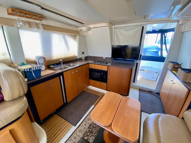 Slide: The Image of Interior of 2002 Bayliner 3488 Command Bridge yacht with kitchen and seating area. - 15