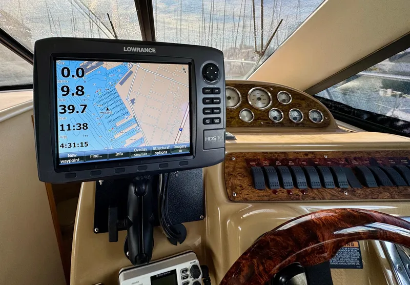 Slide: The Image of 2002 Bayliner 3488 Command Bridge helm with navigation system and control panel. - 16
