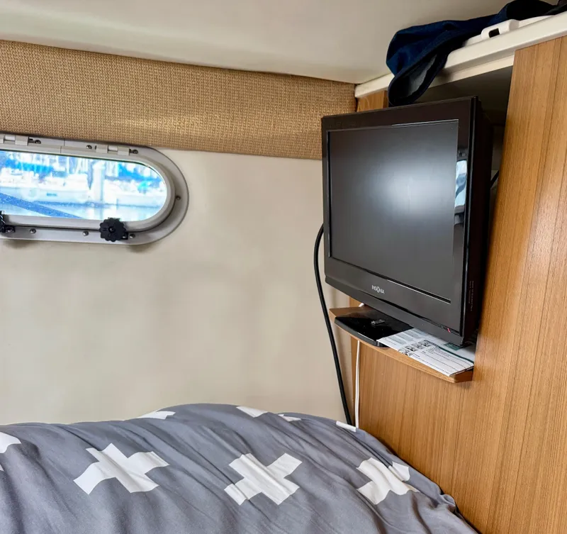 Slide: The Image of 2002 Bayliner 3488 Command Bridge cabin with TV and porthole window. - 18