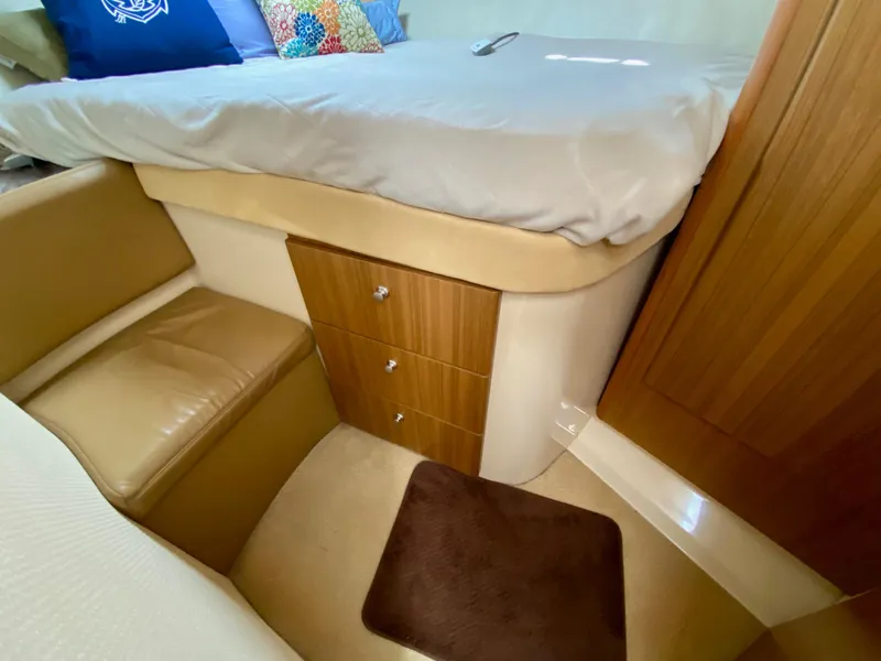 Slide: The Image of 2002 Bayliner 3488 Command Bridge cabin interior with bed, seating, and storage drawers. - 19