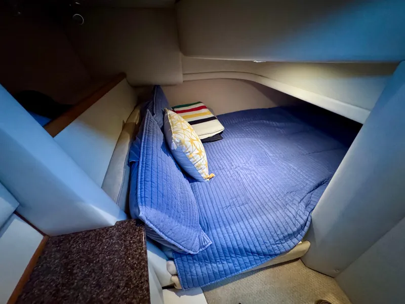 Slide: The Image of Cozy cabin interior of 2002 Bayliner 3488 Command Bridge with blue bedding. - 20