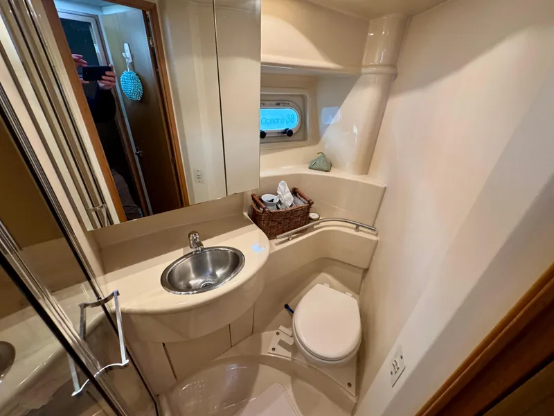 Slide: The Image of 2002 Bayliner 3488 Command Bridge bathroom with sink, toilet, and mirror. - 21