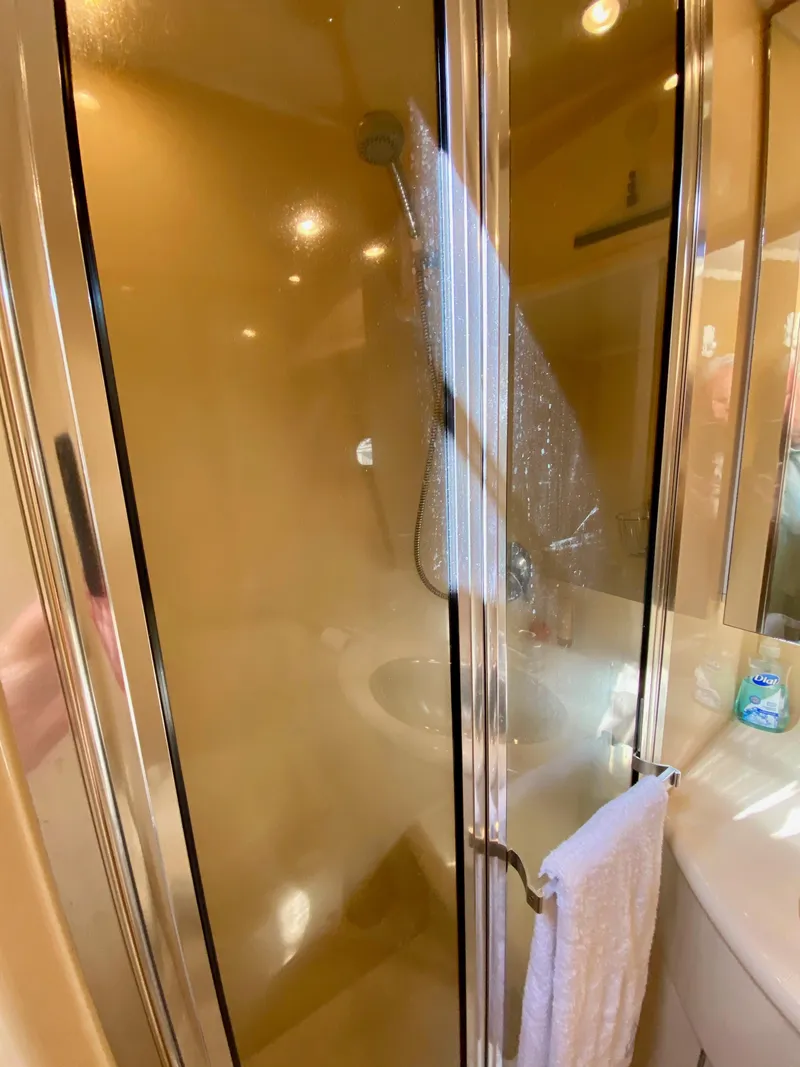 Slide: The Image of 2002 Bayliner 3488 Command Bridge shower with glass door and towel. - 22