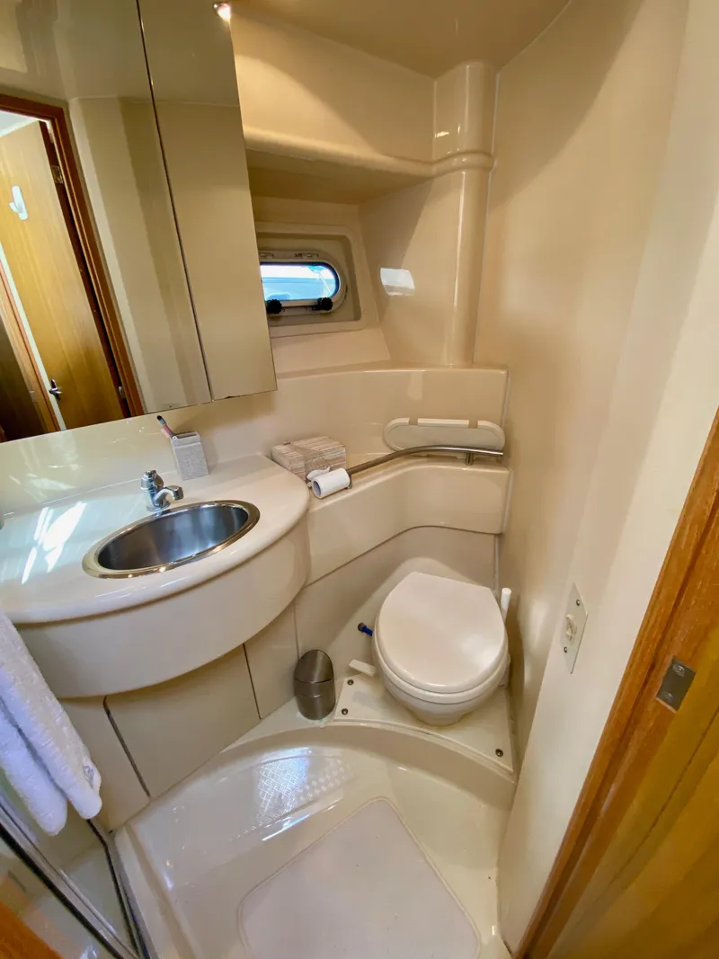Slide: The Image of 2002 Bayliner 3488 Command Bridge bathroom with sink, toilet, and mirror. - 23