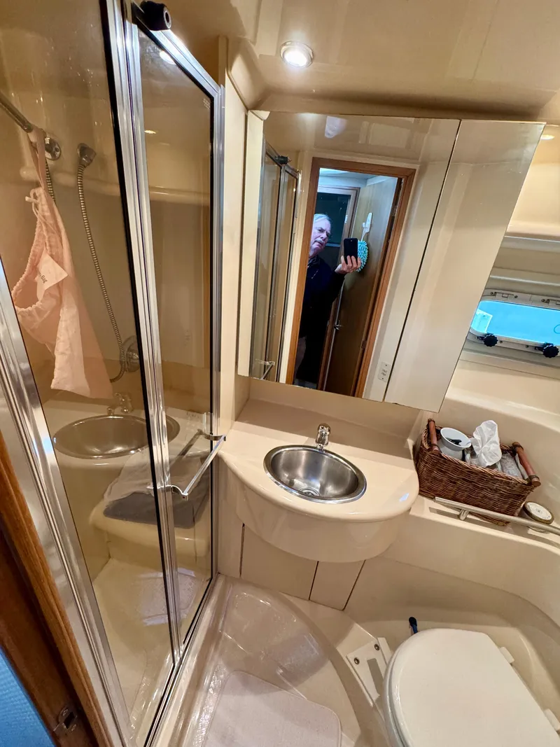 Slide: The Image of 2002 Bayliner 3488 Command Bridge bathroom with shower, sink, and toilet. - 25