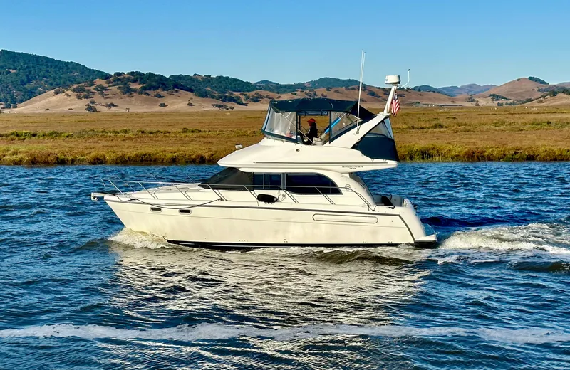 Slide: The Image of 2002 Bayliner 3488 Command Bridge cruising on a scenic waterway. - 3
