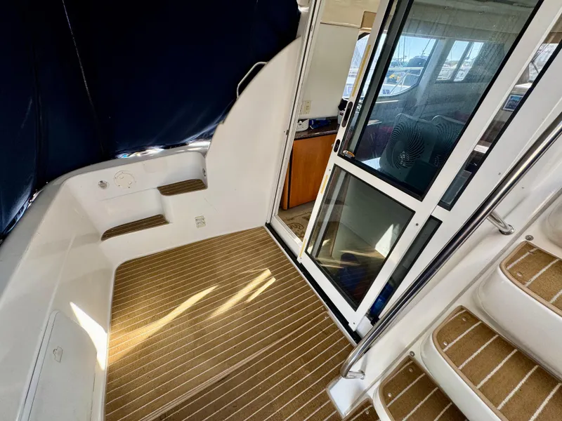Slide: The Image of 2002 Bayliner 3488 Command Bridge interior with steps and sliding door. - 30