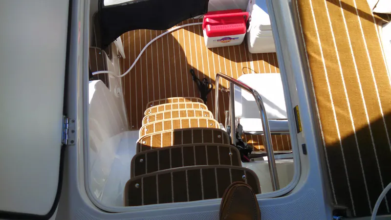 Slide: The Image of Interior view of 2002 Bayliner 3488 Command Bridge with wooden steps and cooler. - 32