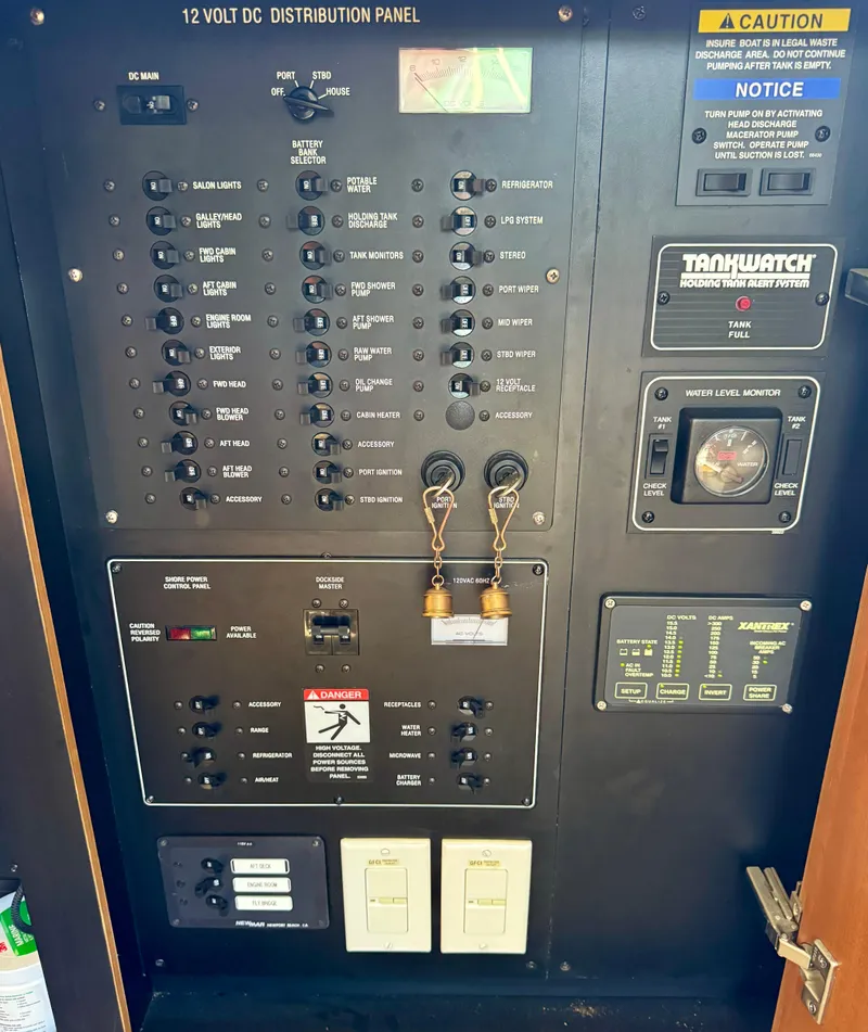 Slide: The Image of 2002 Bayliner 3488 Command Bridge electrical distribution panel with switches and gauges. - 35