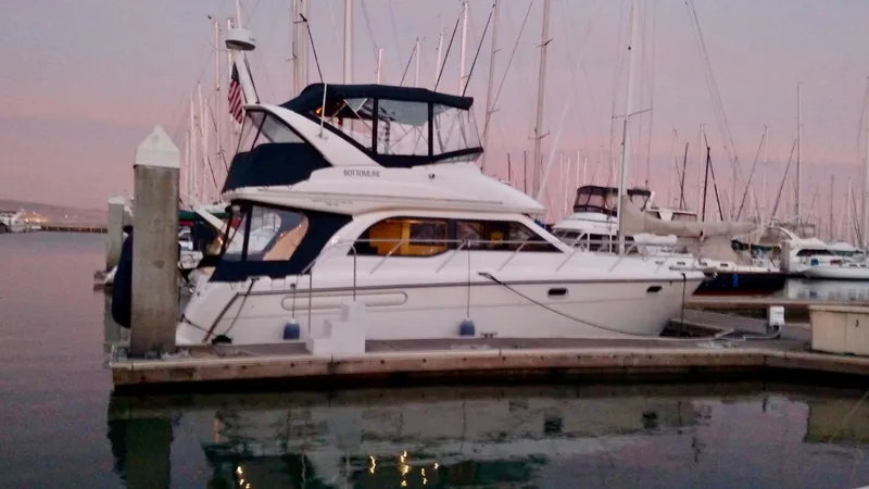 Slide: The Image of 2002 Bayliner 3488 Command Bridge yacht docked at marina during sunset. - 7