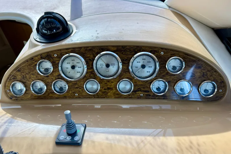 Slide: The Image of Dashboard of 2002 Bayliner 3488 Command Bridge with gauges and controls. - 9