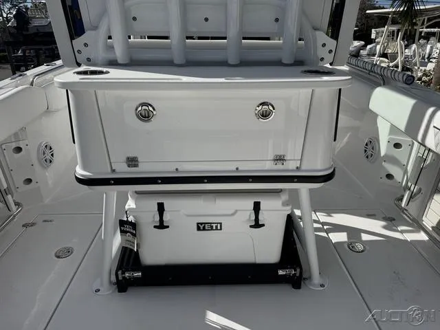 Slide: The Image of 2025 Blackfin 252CC boat interior with Yeti cooler and storage compartments. - 13
