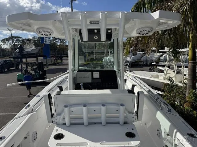 Slide: The Image of 2025 Blackfin 252CC boat interior with rod holders and navigation equipment. - 14