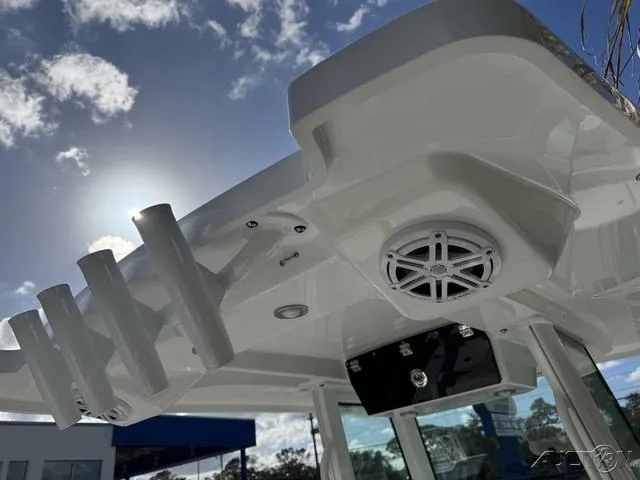 Slide: The Image of 2025 Blackfin 252CC boat with rod holders and speaker, under a sunny sky. - 15