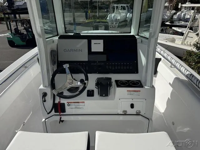 Slide: The Image of 2025 Blackfin 252CC boat console with Garmin navigation system and steering wheel. - 16