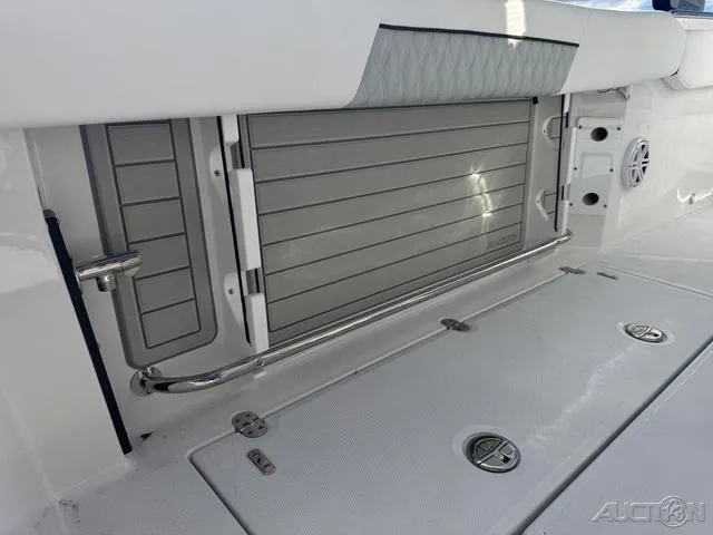 Slide: The Image of 2025 Blackfin 252CC boat interior with storage compartment and sleek design. - 17