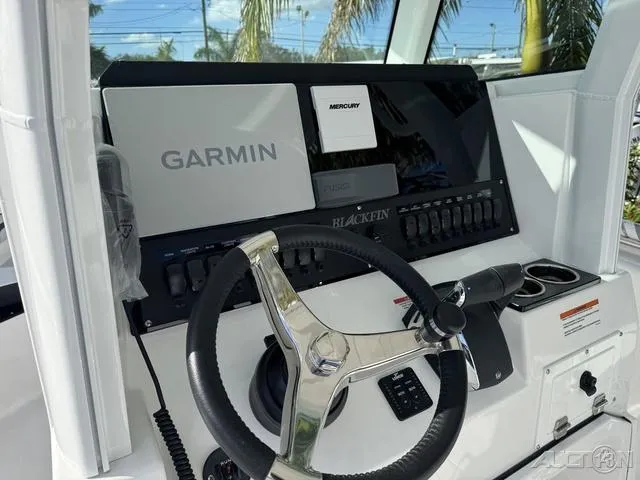 Slide: The Image of 2025 Blackfin 252CC boat dashboard with Garmin and Mercury controls. - 20