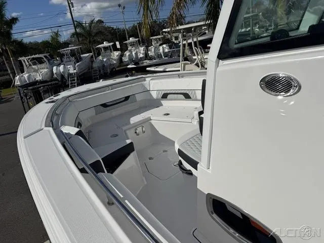 Slide: The Image of 2025 Blackfin 252CC boat interior with seating and storage, docked under clear skies. - 21