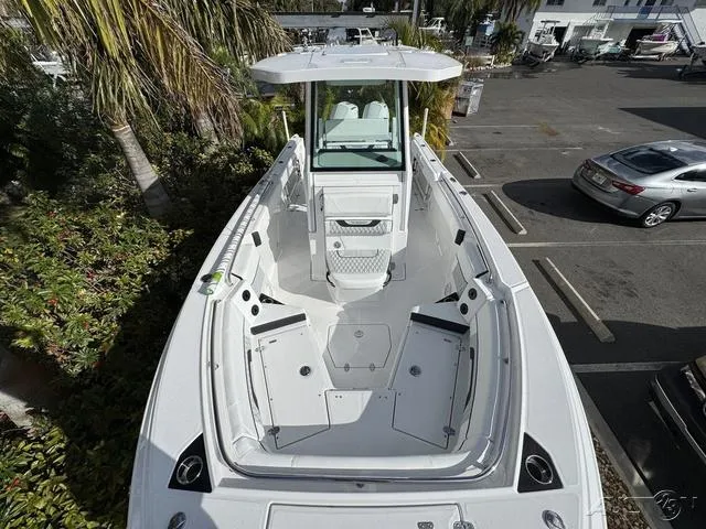 Slide: The Image of 2025 Blackfin 252CC boat, aerial view, docked in a marina parking area. - 24
