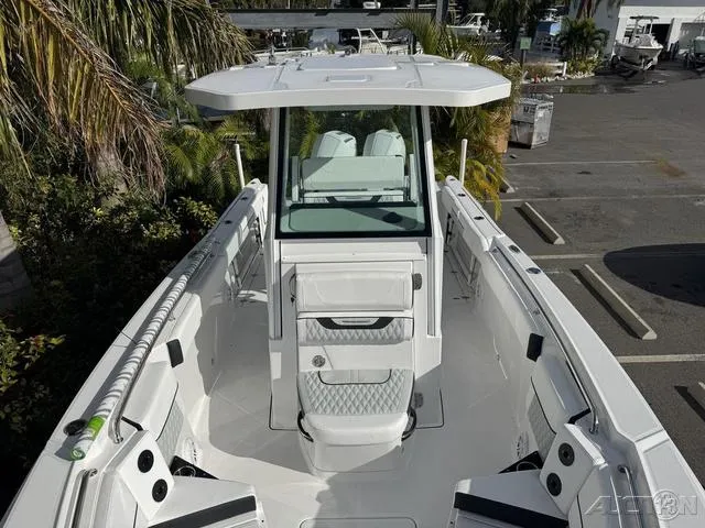 Slide: The Image of 2025 Blackfin 252CC boat with sleek white design and spacious deck. - 25