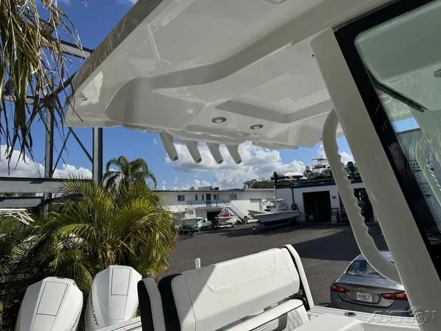 Slide: The Image of 2025 Blackfin 252CC boat with sleek design, docked under clear skies. - 27