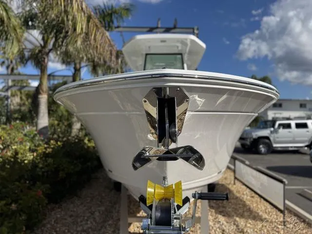Slide: The Image of 2025 Blackfin 252CC boat on trailer, surrounded by palm trees and clear blue sky. - 4