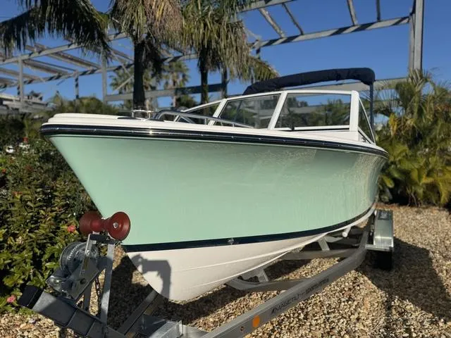 Slide: The Image of 2025 Rossiter 20 boat on trailer, surrounded by tropical plants. - 3