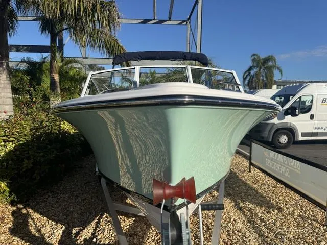 Slide: The Image of 2025 Rossiter 20 boat on trailer, surrounded by tropical plants. - 4