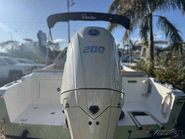 Slide: The Image of 2025 Rossiter 20 boat with Yamaha 200 outboard motor, parked outdoors. - 8