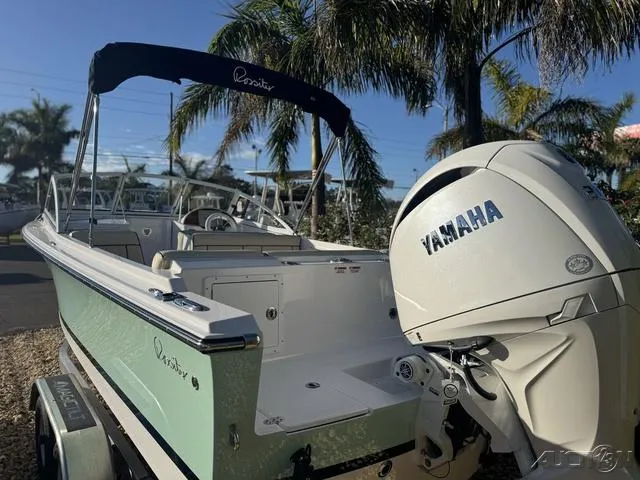 Slide: The Image of 2025 Rossiter 20 boat with Yamaha engine, parked near palm trees. - 9