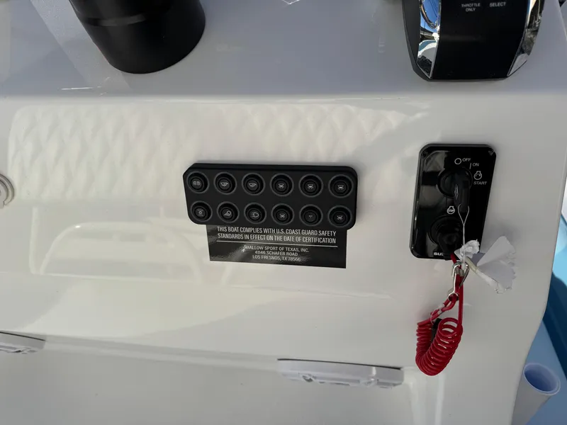 Slide: The Image of Control panel of 2025 Shallow Sport 24 Sport boat with safety features. - 14