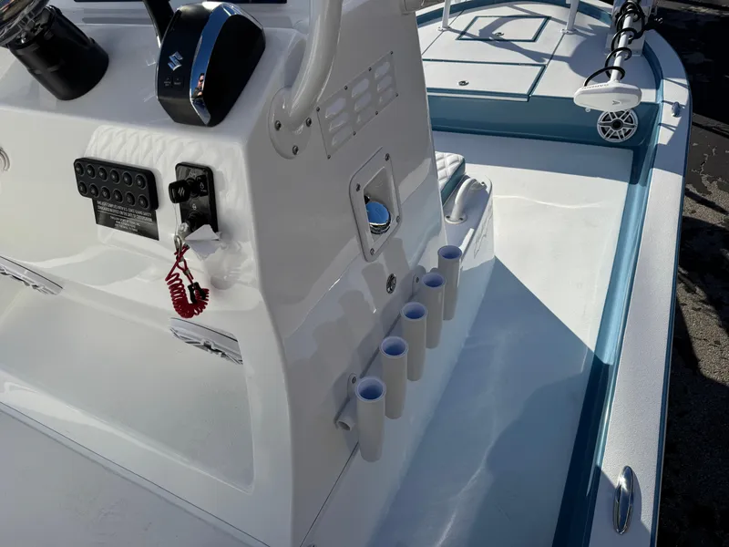 Slide: The Image of 2025 Shallow Sport 24 Sport boat console with rod holders and controls. - 16