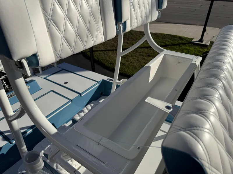 Slide: The Image of 2025 Shallow Sport 24 Sport boat with white cushioned seating and storage compartment. - 23