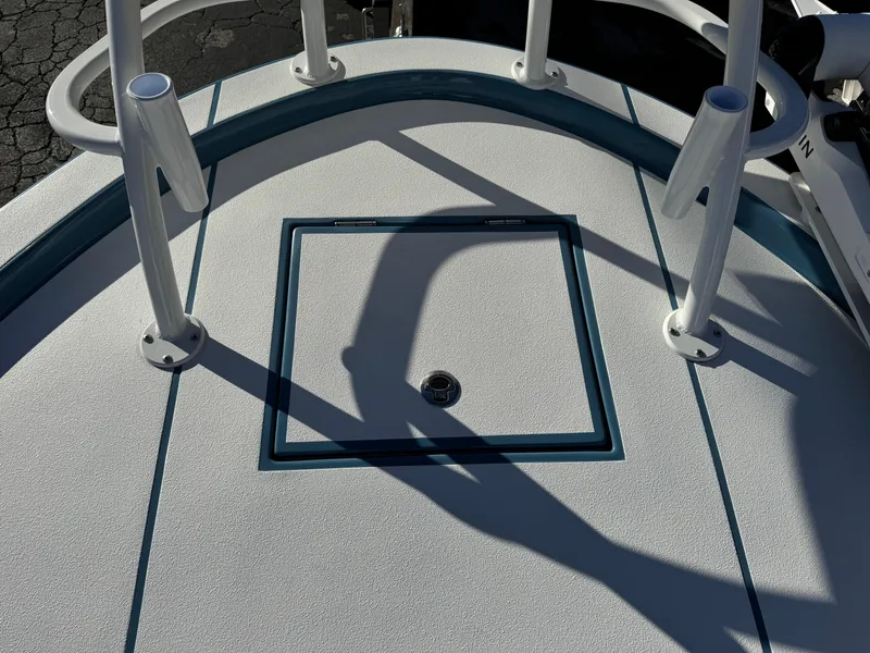 Slide: The Image of 2025 Shallow Sport 24 Sport boat deck with storage hatch and rod holders. - 27