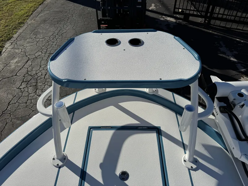 Slide: The Image of 2025 Shallow Sport 24 Sport boat deck with rod holders and textured surface. - 29