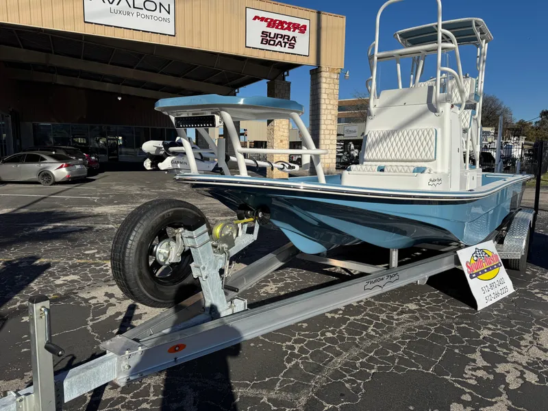 Slide: The Image of 2025 Shallow Sport 24 Sport boat on trailer outside dealership. - 3