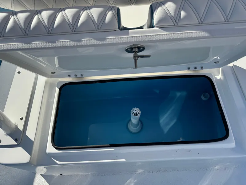 Slide: The Image of 2025 Shallow Sport 24 Sport boat livewell with cushioned seating. - 31
