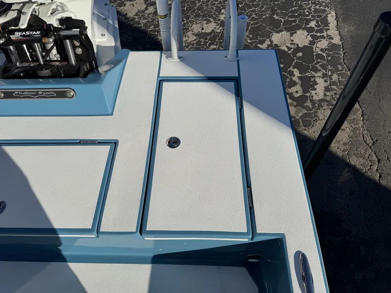 Slide: The Image of 2025 Shallow Sport 24 Sport boat deck with storage compartments and Seastar steering system. - 35